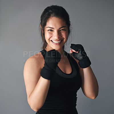 Buy stock photo Studio shot of a female kickboxer against a gray background