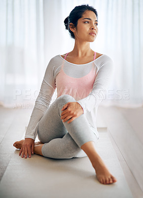 Buy stock photo Shot of an attractive young woman doing yoga at home