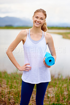 Buy stock photo Portrait shot of a young woman 
holding a yoga mat outdoors