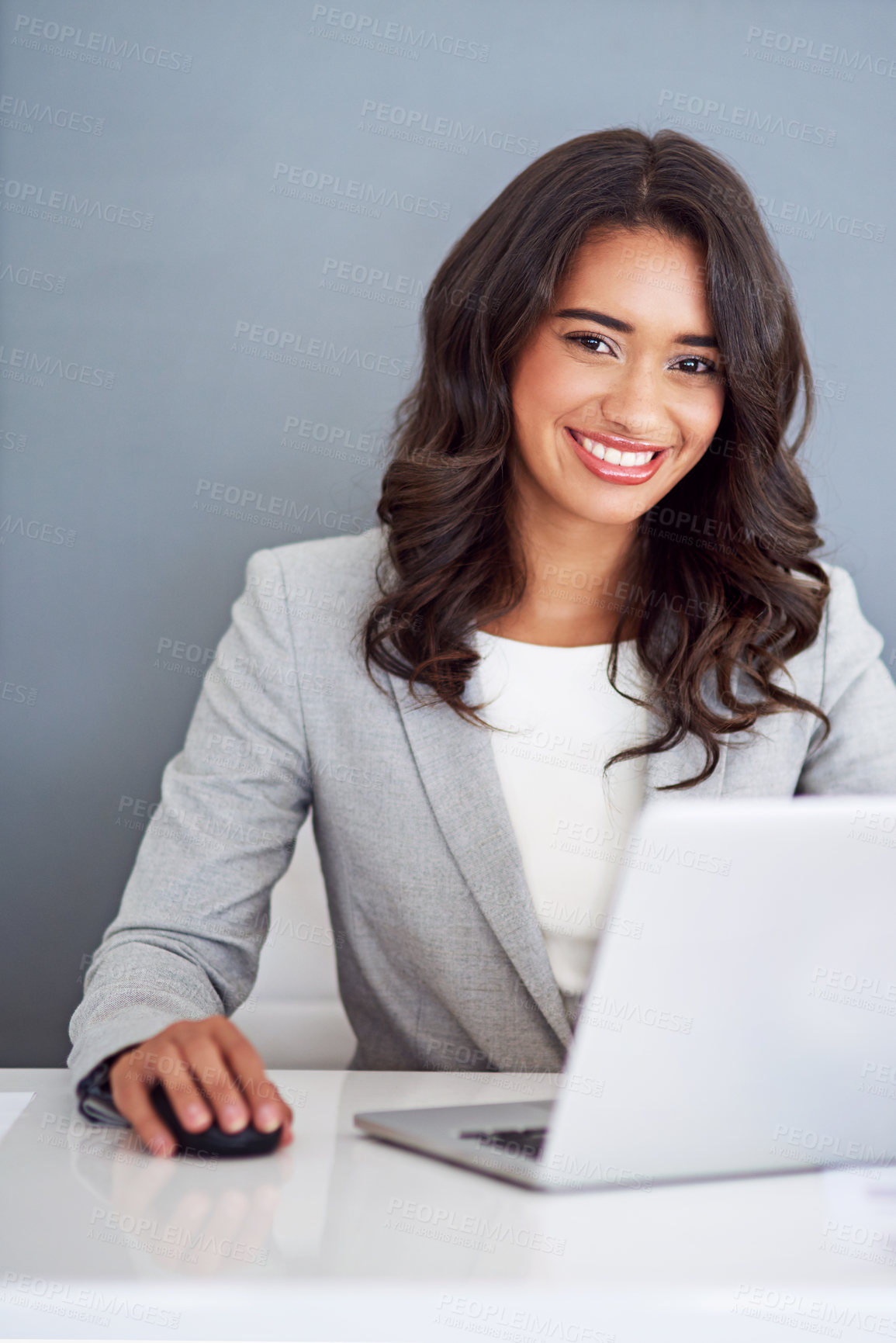 Buy stock photo Cropped portrait of a young businesswoman working on her laptop