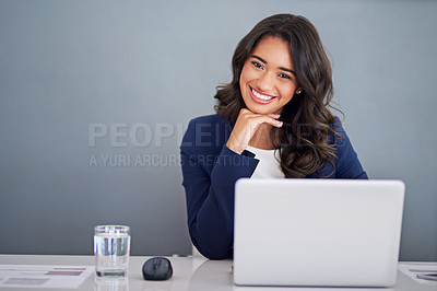Buy stock photo Cropped portrait of a young businesswoman working on her laptop