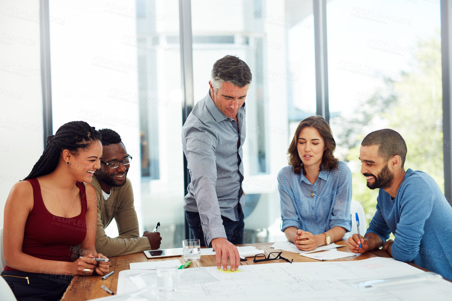 Buy stock photo Architecture, business people and collaboration with blueprint in office for planning home remodeling project. Laughing, architect and pointing to floor plan for building design, draft and diversity