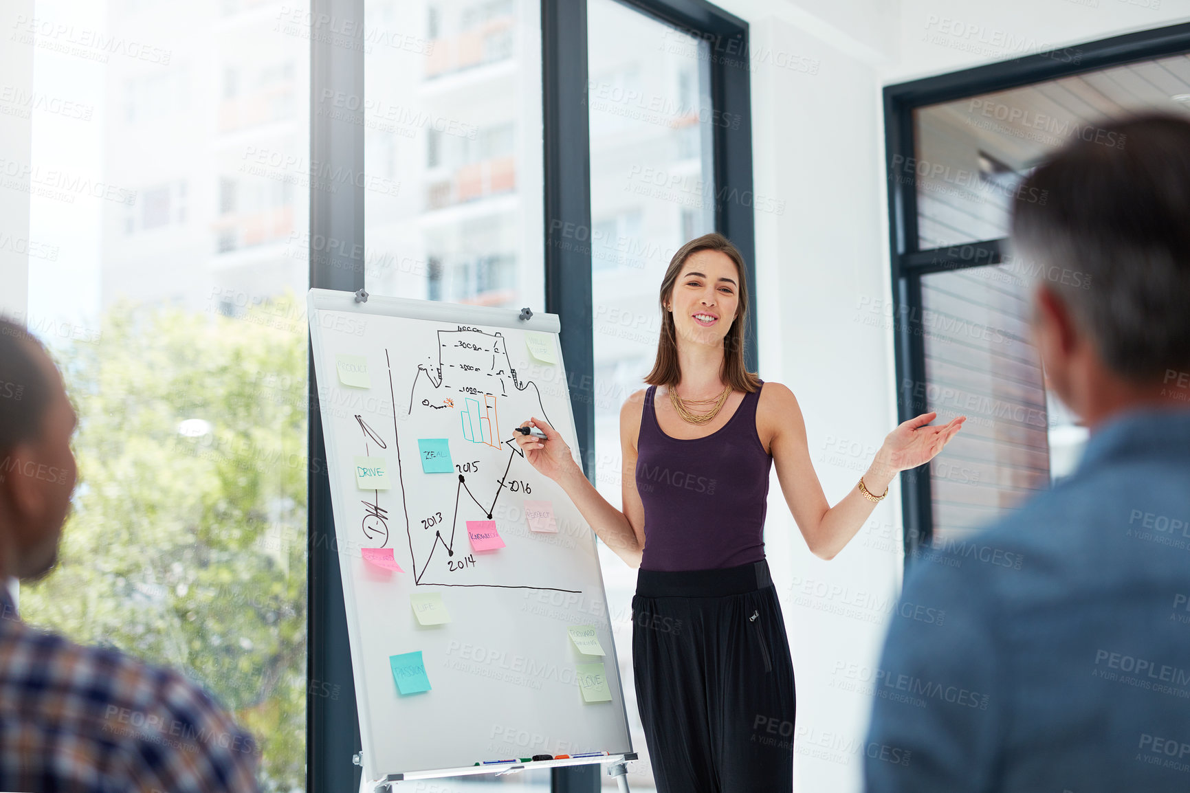 Buy stock photo Shot of a young businesswoman giving a presentation in the boardroom