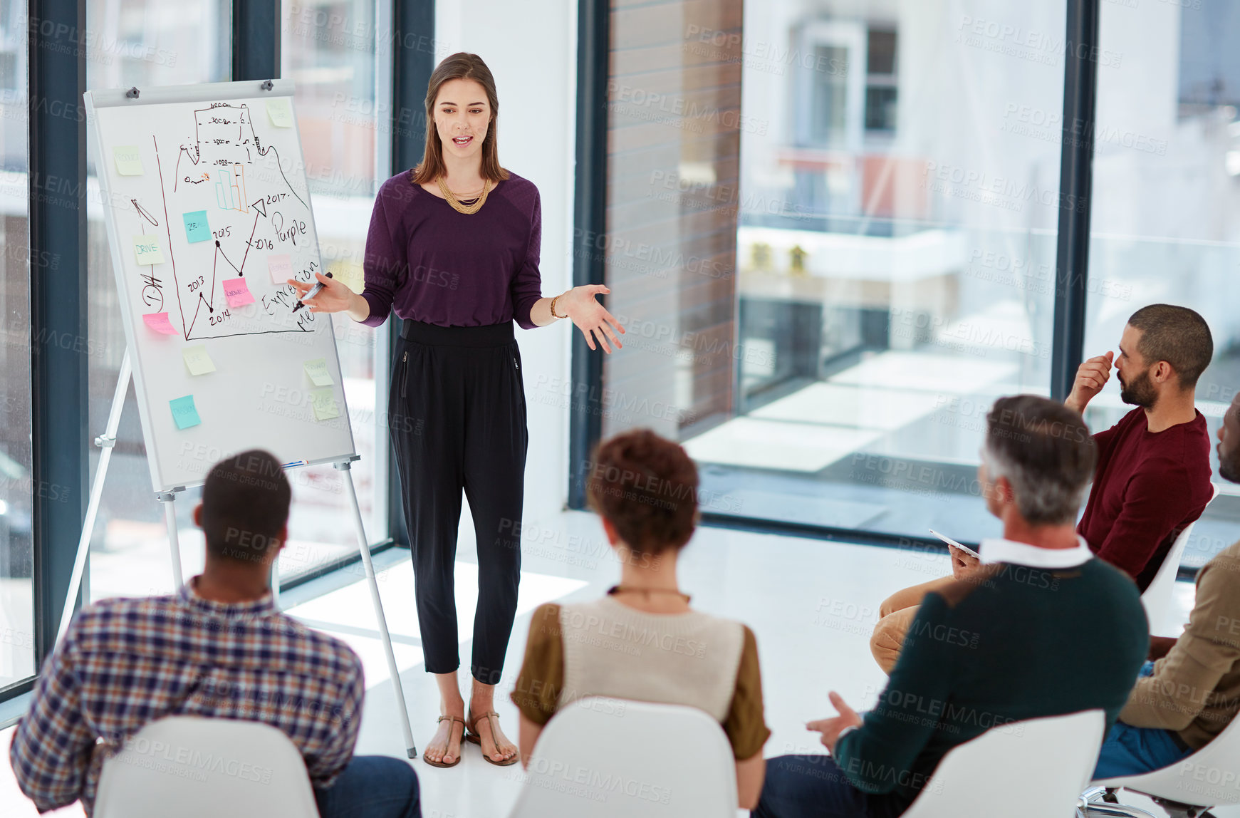 Buy stock photo Shot of a young businesswoman giving a presentation in the boardroom