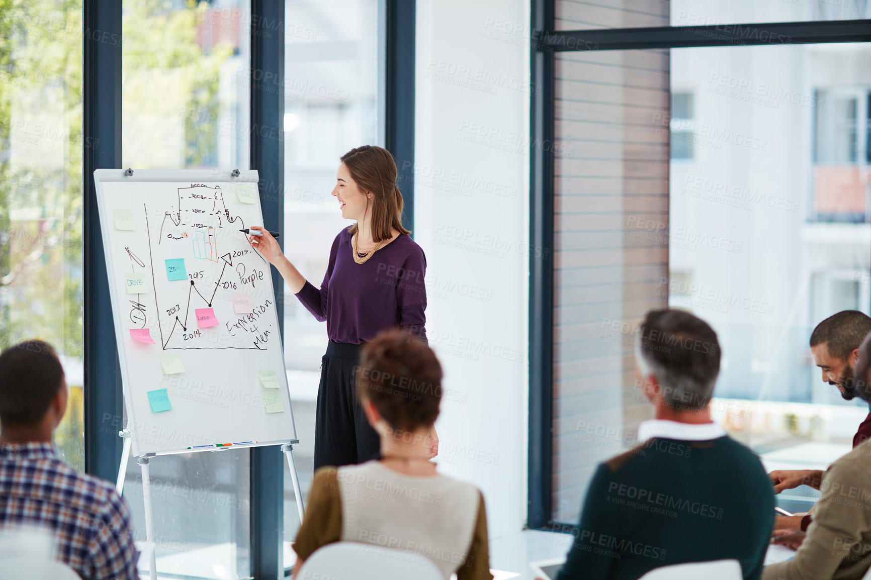 Buy stock photo Shot of a young businesswoman giving a presentation in the boardroom