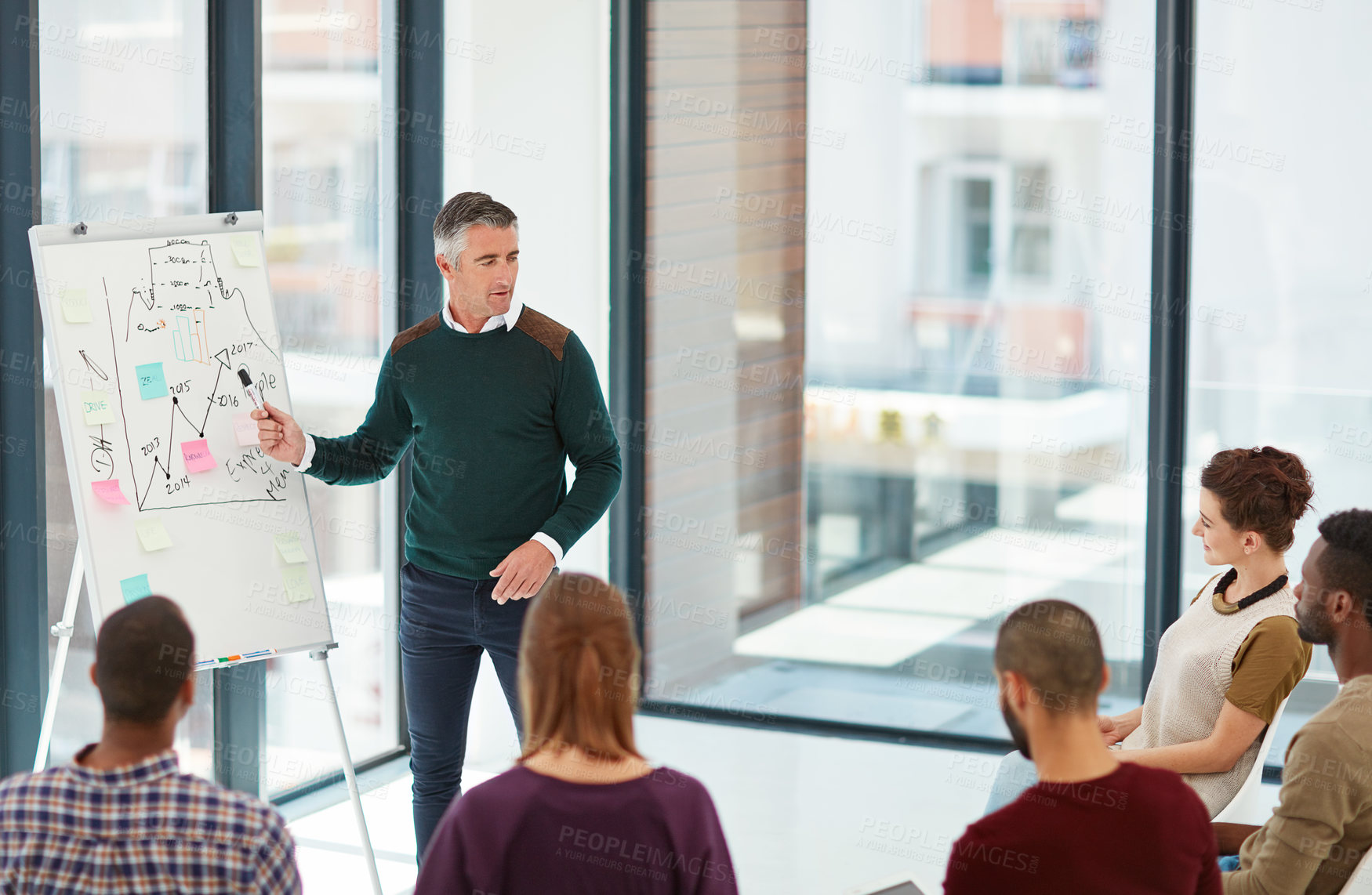 Buy stock photo Shot of a mature businessman giving a presentation in the boardroom