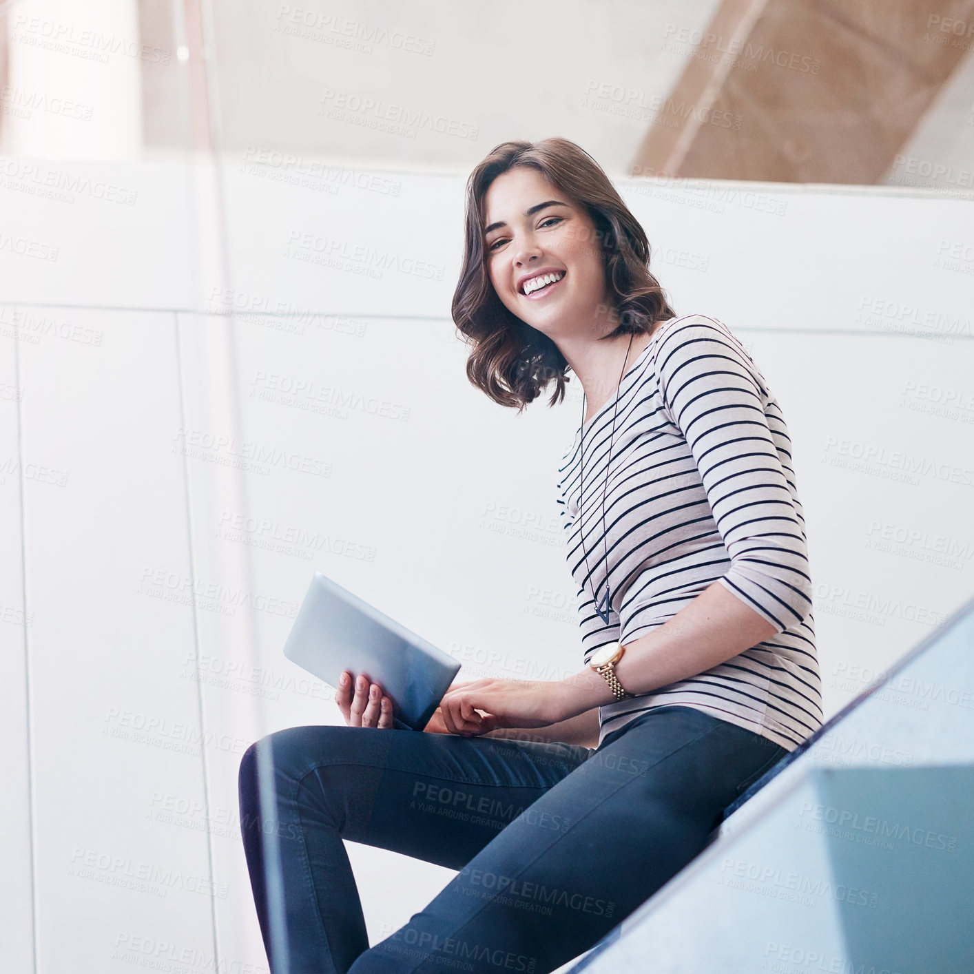 Buy stock photo Portrait of a young businesswoman using a digital tablet on the stairs in a modern office