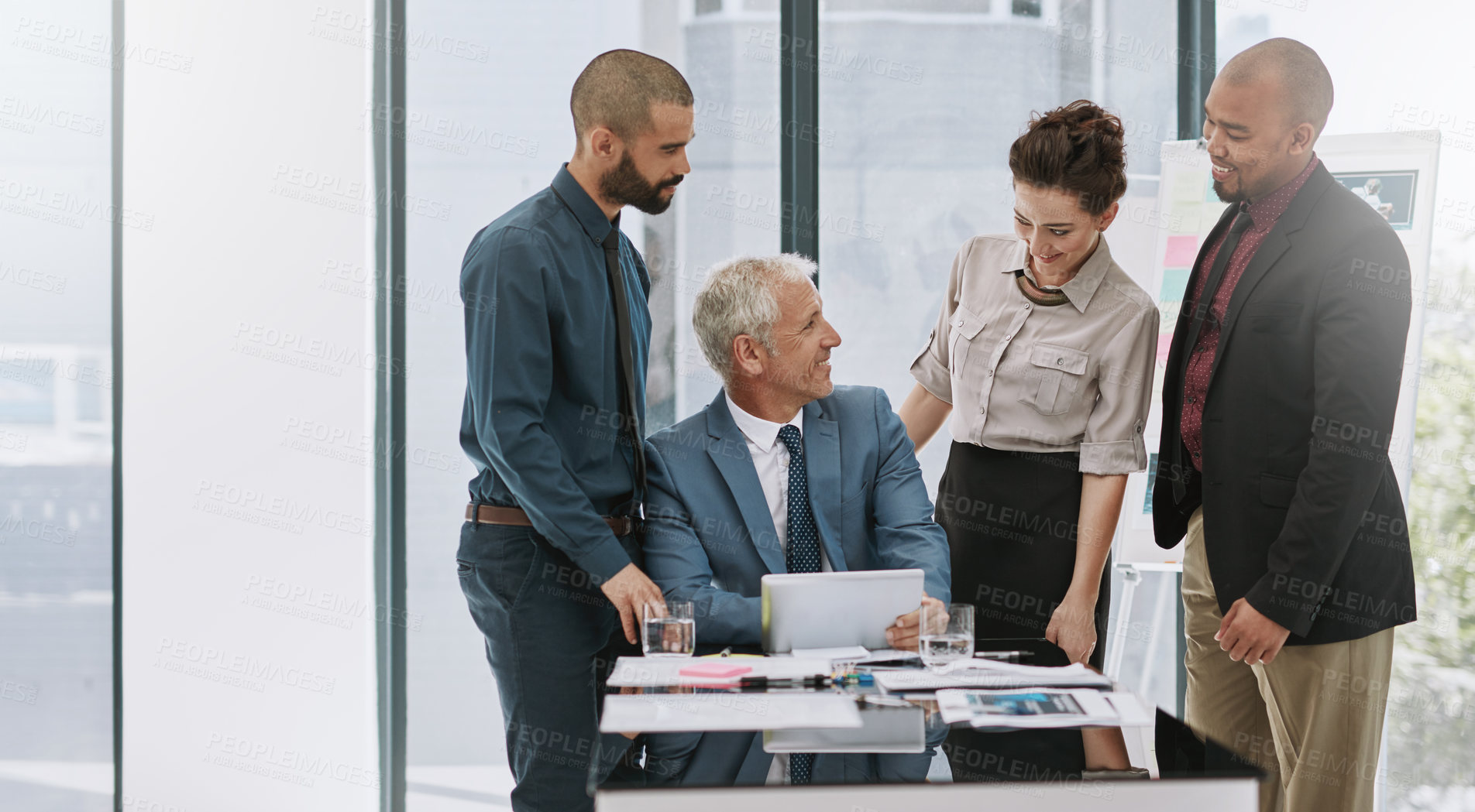 Buy stock photo Meeting, good news and happy business people with tablet for technology, teamwork or partnership. Diversity, smile or executive director talking to investors for project review, paperwork or briefing