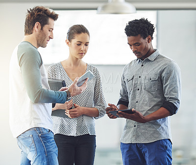 Buy stock photo Cropped shot of three young designers talking in the office