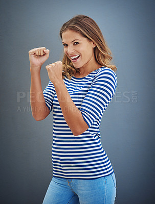 Buy stock photo Studio shot of a young woman putting up her fists against a gray background