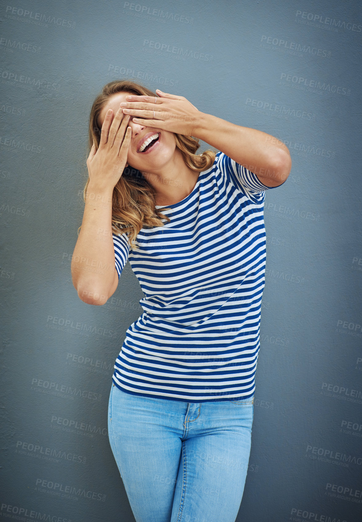 Buy stock photo Girl, happy and hands with covering eyes in studio backdrop for fashion with joy for confidence, trendy or style. Female person, outfit and fun in isolated, casual and aesthetic in gray background