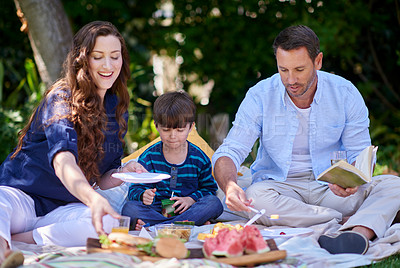 Buy stock photo Shot of a family having a picnic in the park