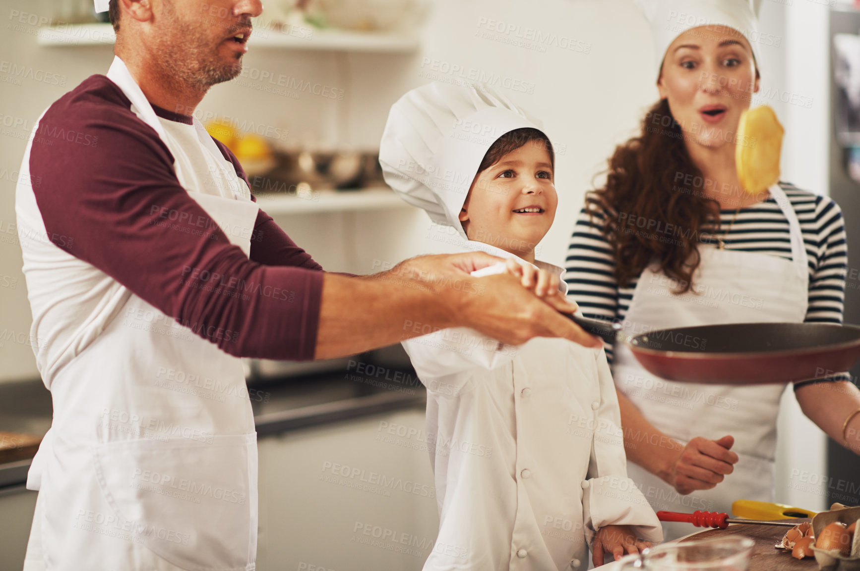 Buy stock photo Flip, family and child with pancake in kitchen for growth development to prepare cookies in home. Father, mom or kid learning pastry tricks or games for bonding, cooking dessert or playing together