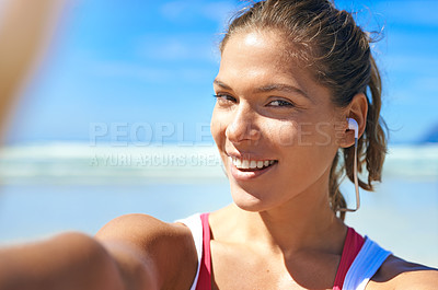 Buy stock photo Selfie, fitness and woman with earphones for music and exercise motivation, smile at beach and nature with blue sky. Happy in outdoor picture, listen to podcast in workout, active life portrait.