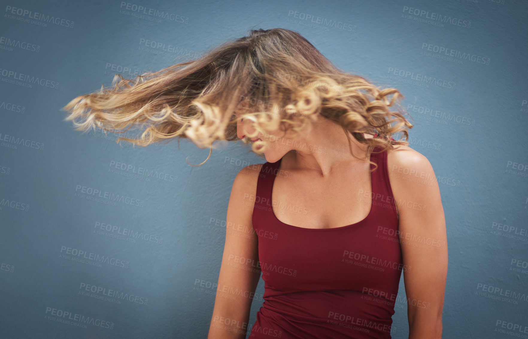 Buy stock photo Woman, beauty and shake hair with health for growth, textures and confidence in studio. Female person, moving curls and haircare for salon aesthetic with fun, energy and shine by gray background