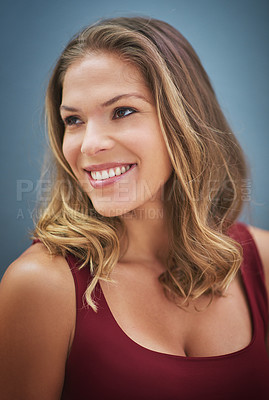 Buy stock photo Thinking, happy and woman with a vision, smile and happiness against a blue background in studio. Idea, hair care and face of a salon model with natural beauty, young and confident on a wall