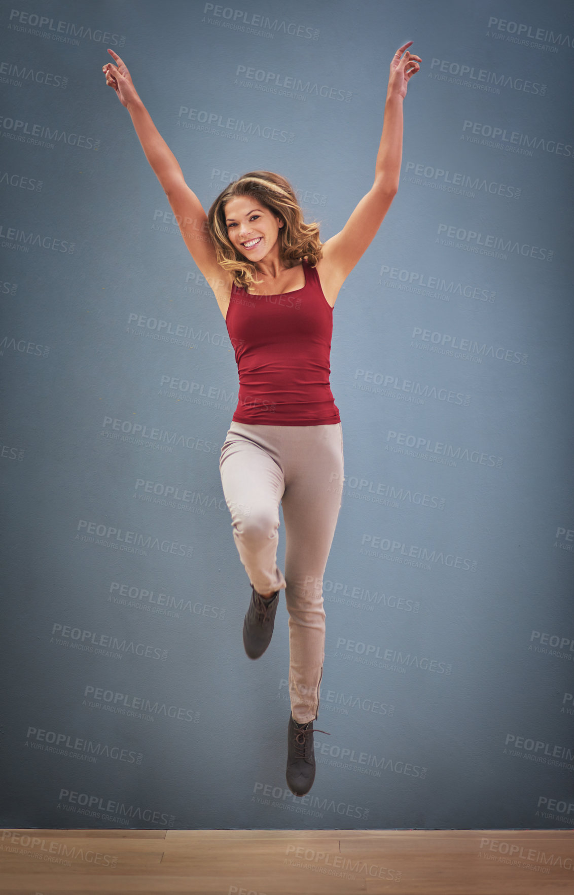 Buy stock photo Portrait, jump or woman in studio mockup with arms up, excited or ready for dance. Female person, happy or energy on blue background space for healthy body, ambition or positive attitude in Australia