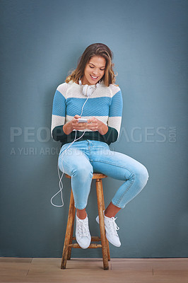 Buy stock photo Shot of a young woman listening to music