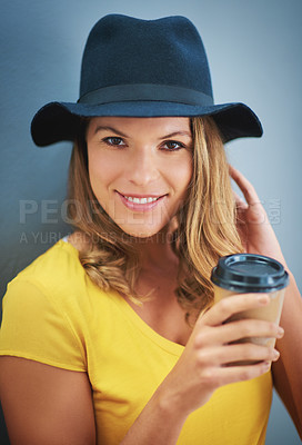 Buy stock photo Portrait, coffee and fashion with a model woman in studio on a gray background for contemporary style. Face, hat and drink with an attractive young female hipster drinking a takeaway beverage