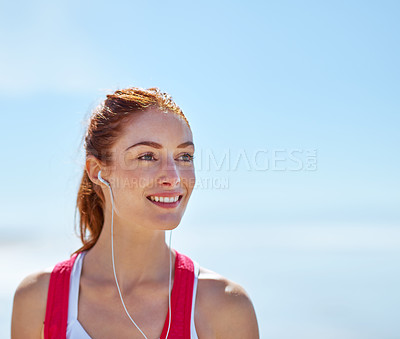 Buy stock photo Happy, fitness and woman with headphones in nature for morning, run and listening to music. Sky, athlete and smile with audio tech on mockup space for exercise podcast, training and outdoor workout