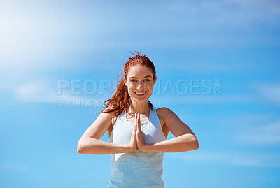 Buy stock photo Shot of a young woman practicing her yoga routine at the beach