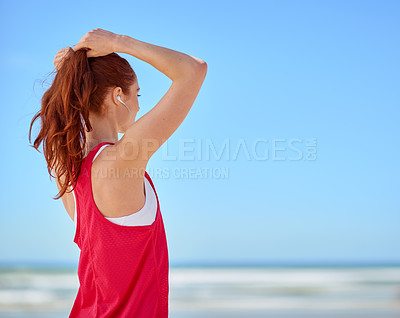 Buy stock photo Cropped shot of a sporty young woman on the beach