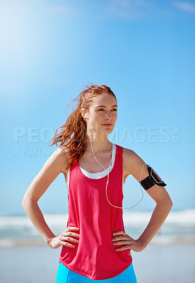 Buy stock photo Runner woman, beach and sky with earphones for music, workout motivation and training by ocean. Athlete girl, exercise and running for wellness by sea waves with focus for fitness, health and outdoor