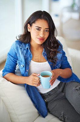 Buy stock photo Shot of a young woman drinking coffee while relaxing at home