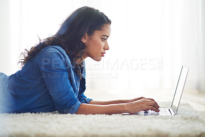 Buy stock photo Floor, laptop and relax with a woman blogger or freelance worker doing remote work from home while lying. Computer, email and technology with a young female online working on her carpet in a house