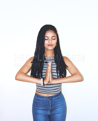 Buy stock photo Studio shot of an attractive young woman standing in a meditation-like position
