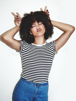 Buy stock photo Peace, fun and fashion with a model black woman in studio on a gray background for contemporary style. Bunny, face and beauty with a female posing inside, pouting her lips with a hand sign or gesture