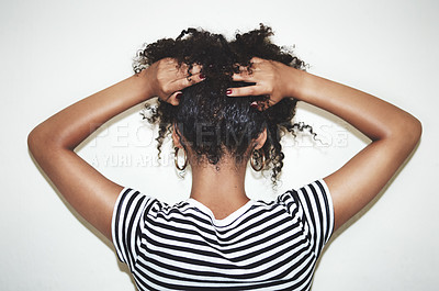 Buy stock photo Rearview studio shot of a woman lifting the hair off of her neck against a gray background