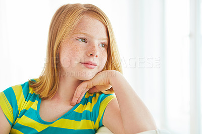 Buy stock photo Shot of a thoughtful little girl at home