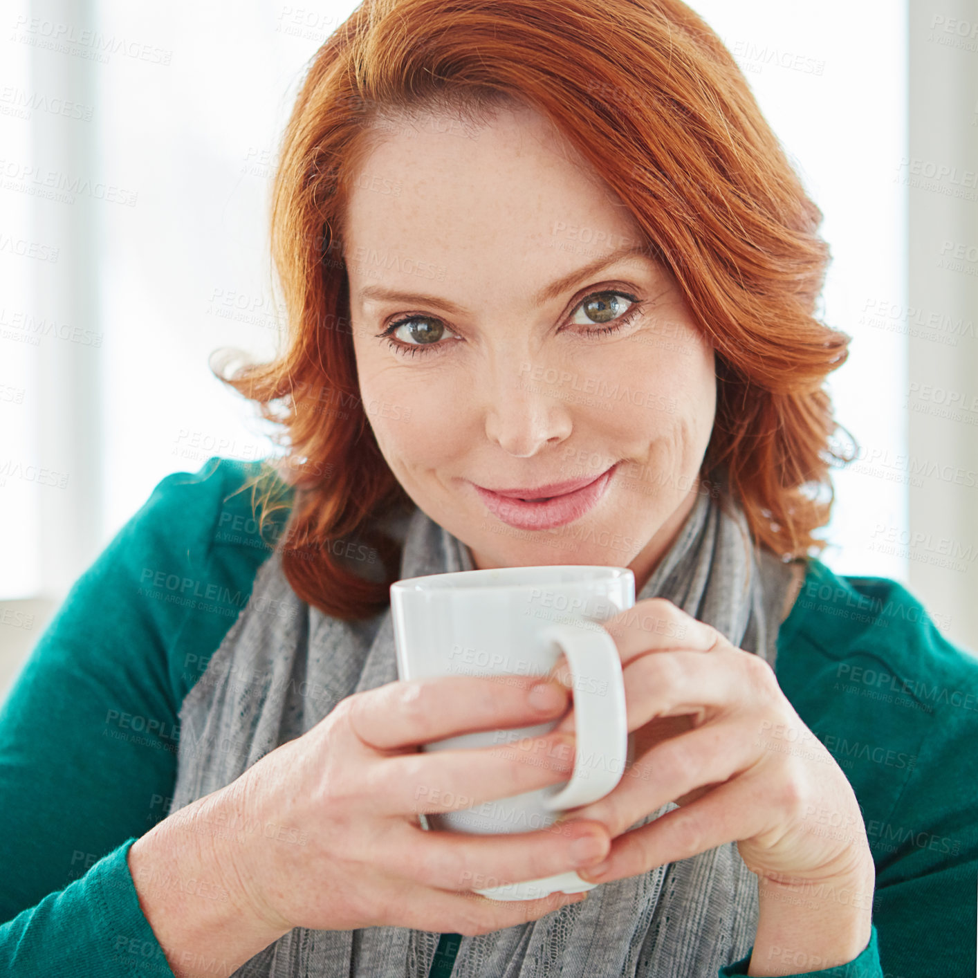 Buy stock photo Cropped portrait of a mature woman drinking coffee while relaxing on the sofa at home