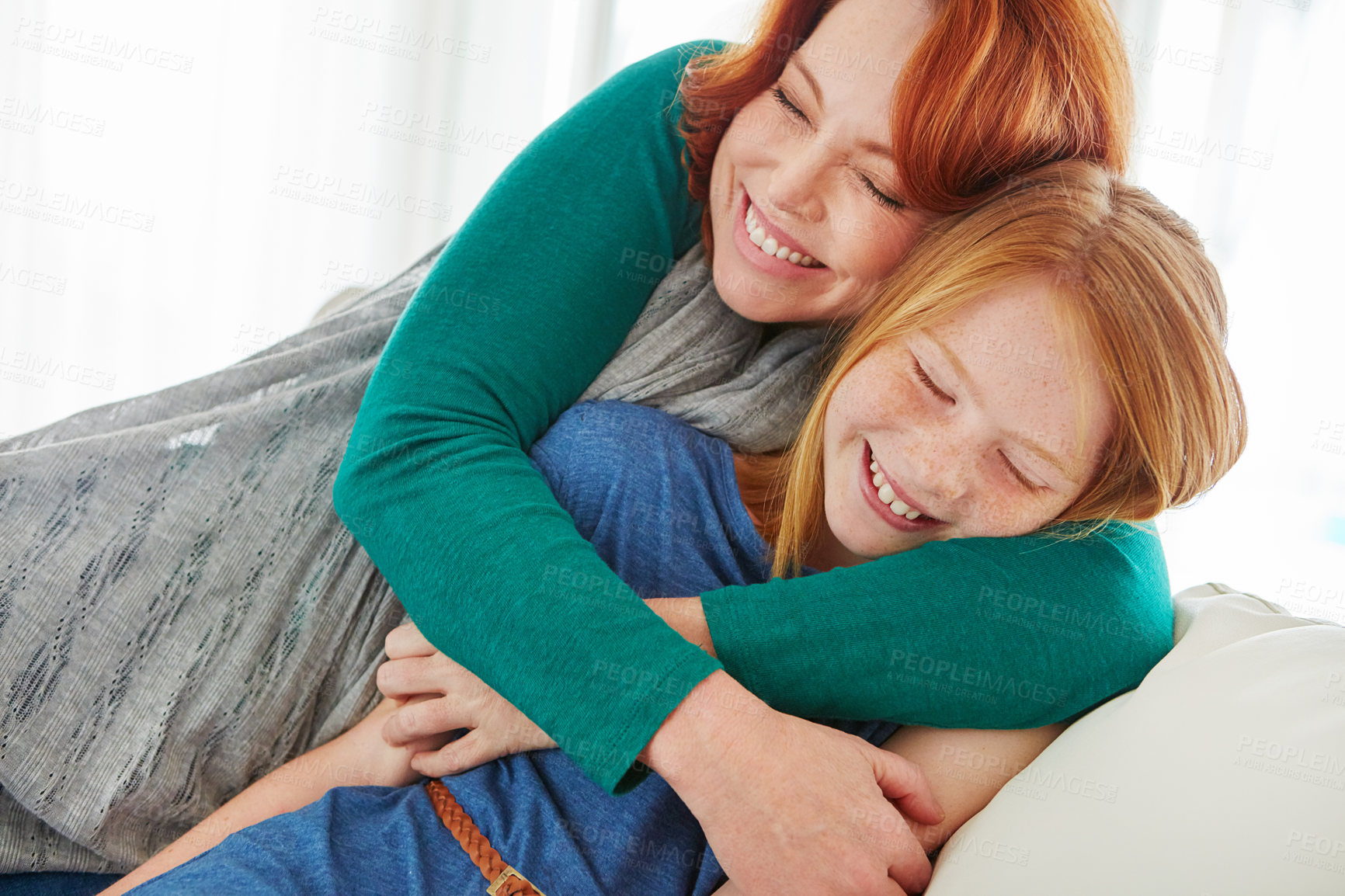 Buy stock photo Shot of a mother and young daughter sitting on the sofa at home