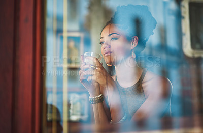 Buy stock photo Cropped shot of an attractive young woman sitting in a coffee shop