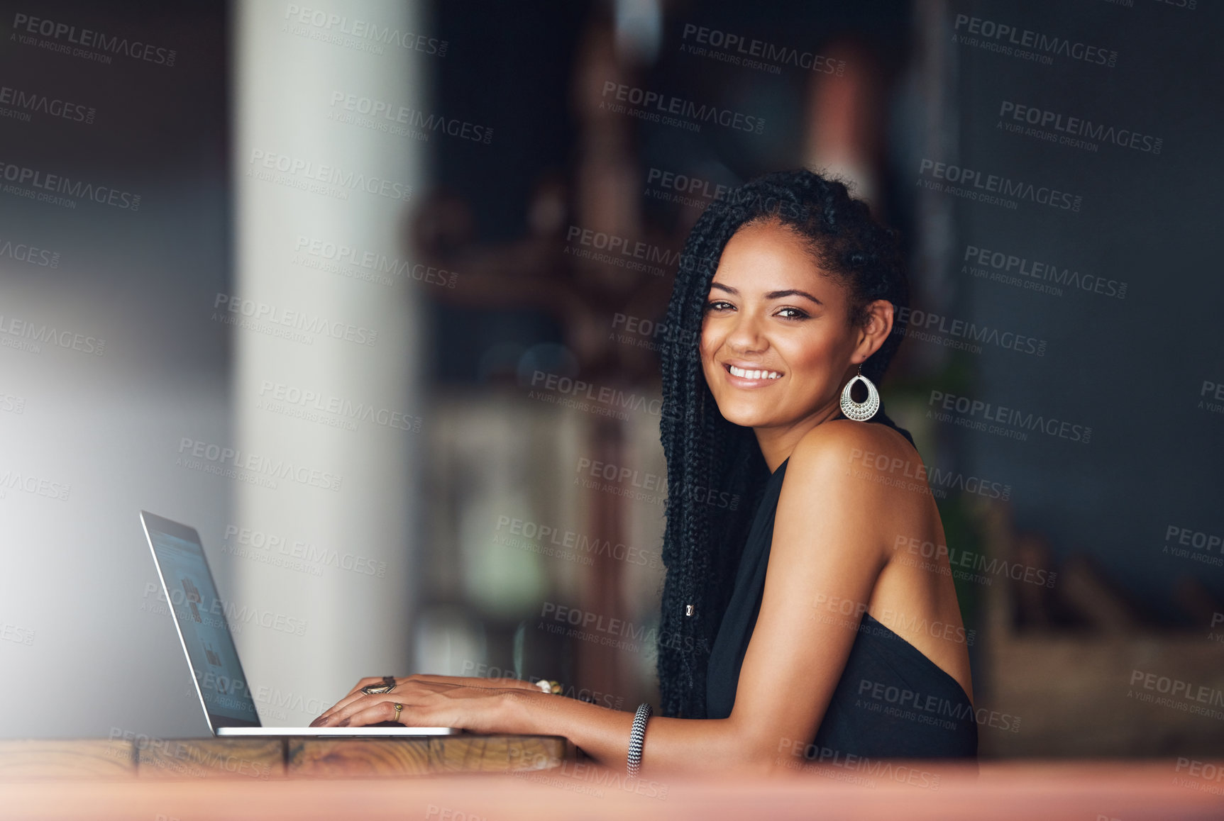 Buy stock photo Cropped portrait of an attractive young woman using her laptop in a coffee shop