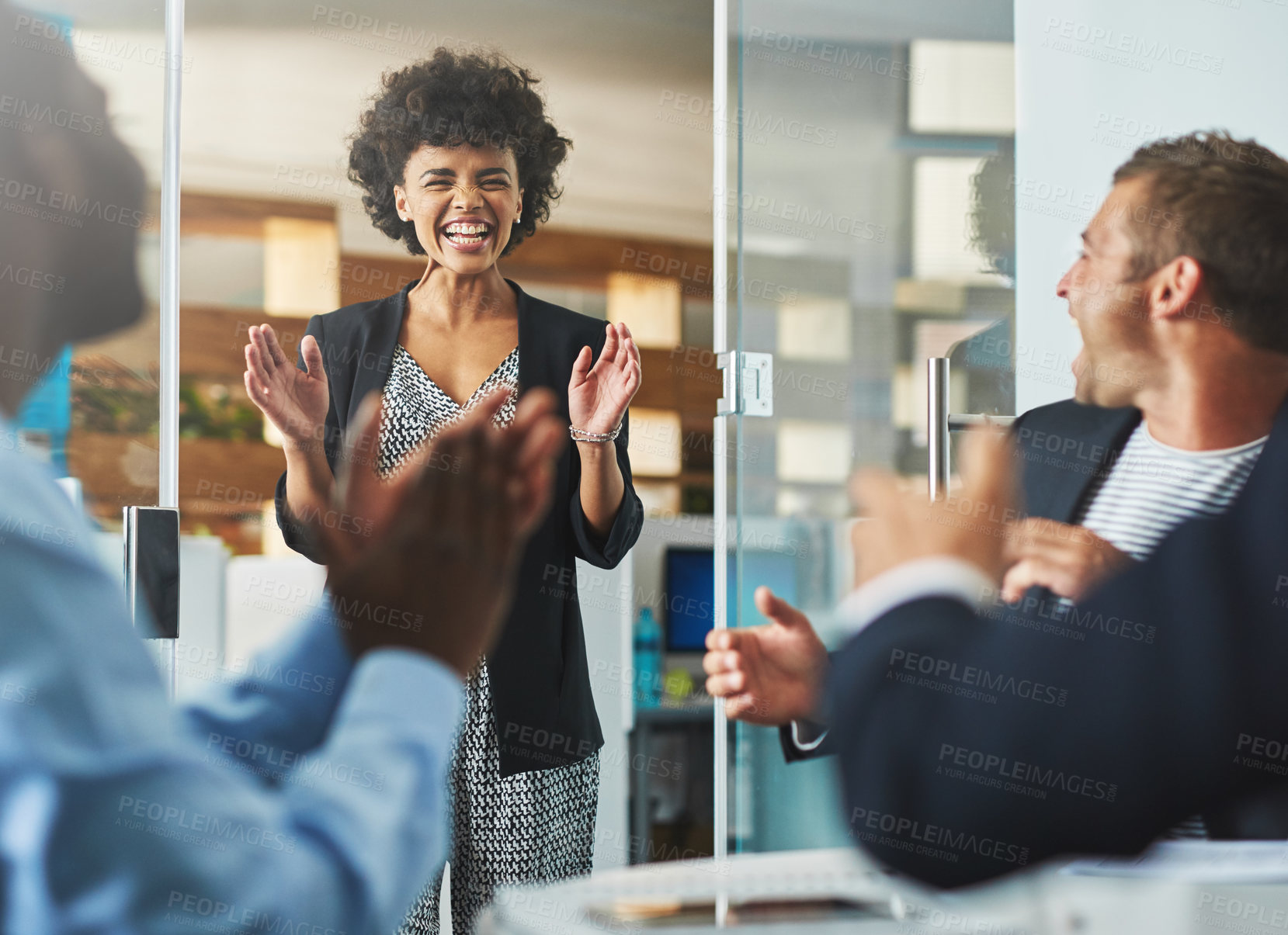 Buy stock photo Shot of colleagues laughing together in an office