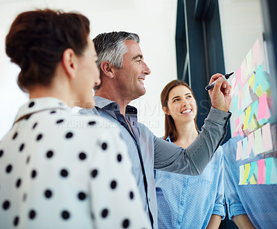 Buy stock photo Business people, brainstorming and sticky notes for planning, strategy or teamwork at the office. Happy creative employee workers in team meeting collaboration, post it and schedule or project plan