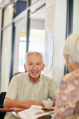 Buy stock photo Shot of a smiling senior couple taking together in a cafe