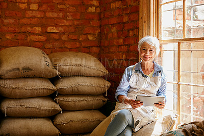 Buy stock photo Cropped portrait of a senior woman using a tablet while working in a roastery