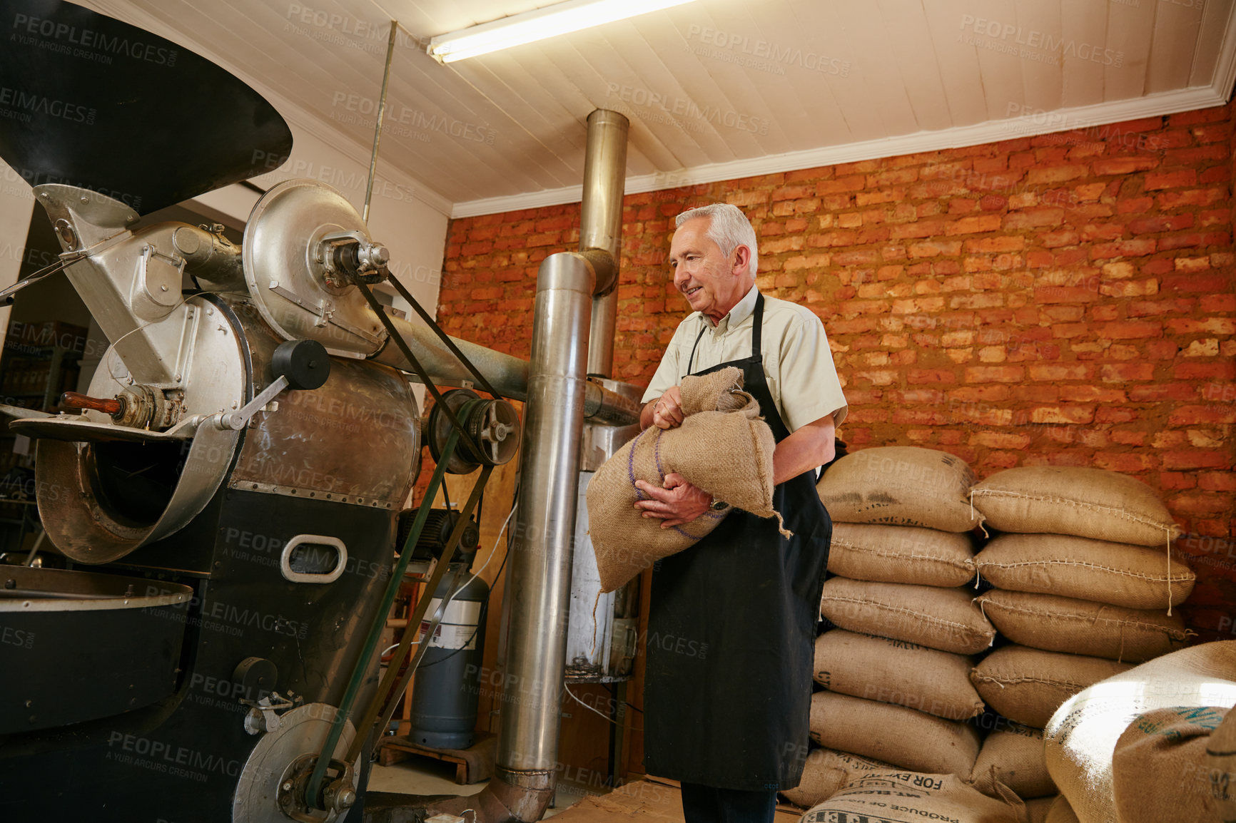 Buy stock photo Cropped shot of a senior man working in a roastery