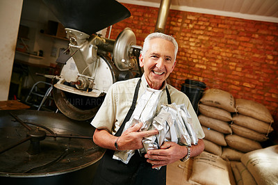 Buy stock photo Cropped portrait of a senior man holding bags of coffee beans while working in a roastery