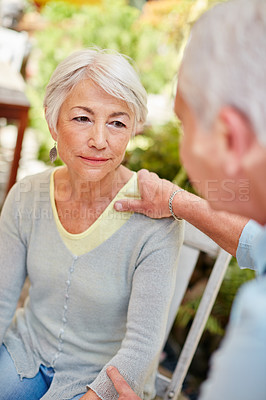 Buy stock photo Shot of a caring husband comforting his senior wife