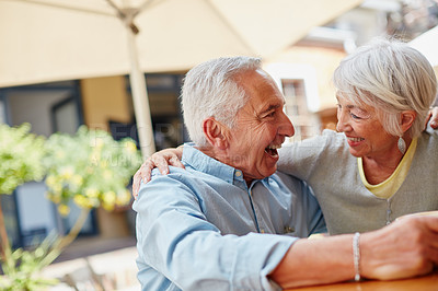 Buy stock photo Shot of a happy senior couple spending time together at a cafe