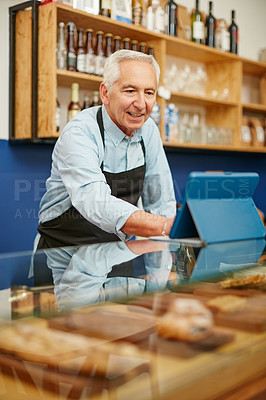 Buy stock photo Shot of a senior man working in a bakery