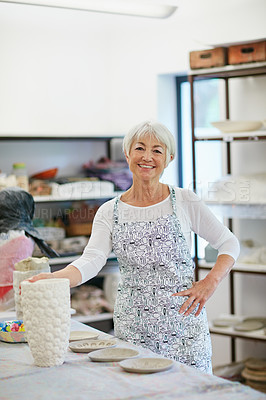 Buy stock photo Shot of a senior woman making a ceramic pot in a workshop