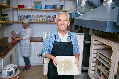 Buy stock photo Shot of a senior couple working with ceramics in a workshop