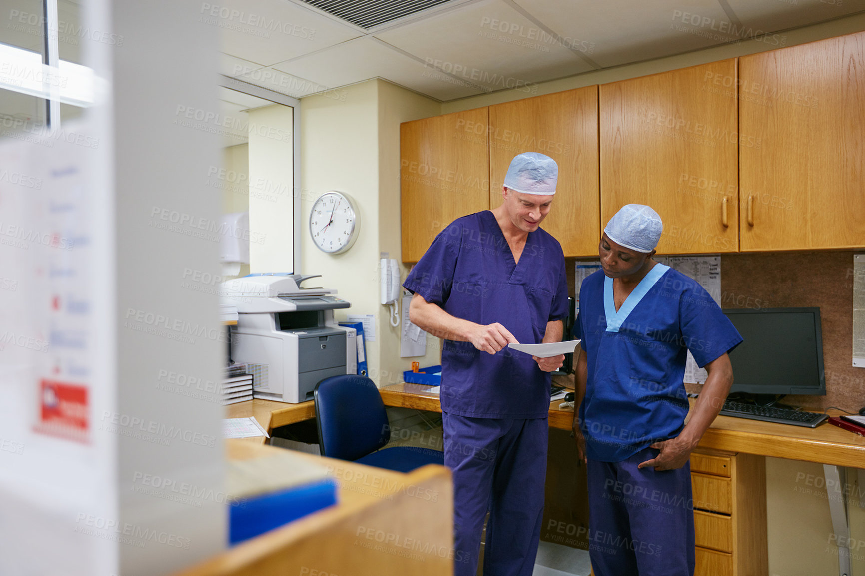 Buy stock photo Shot of two surgeons having a discussion in a hospital