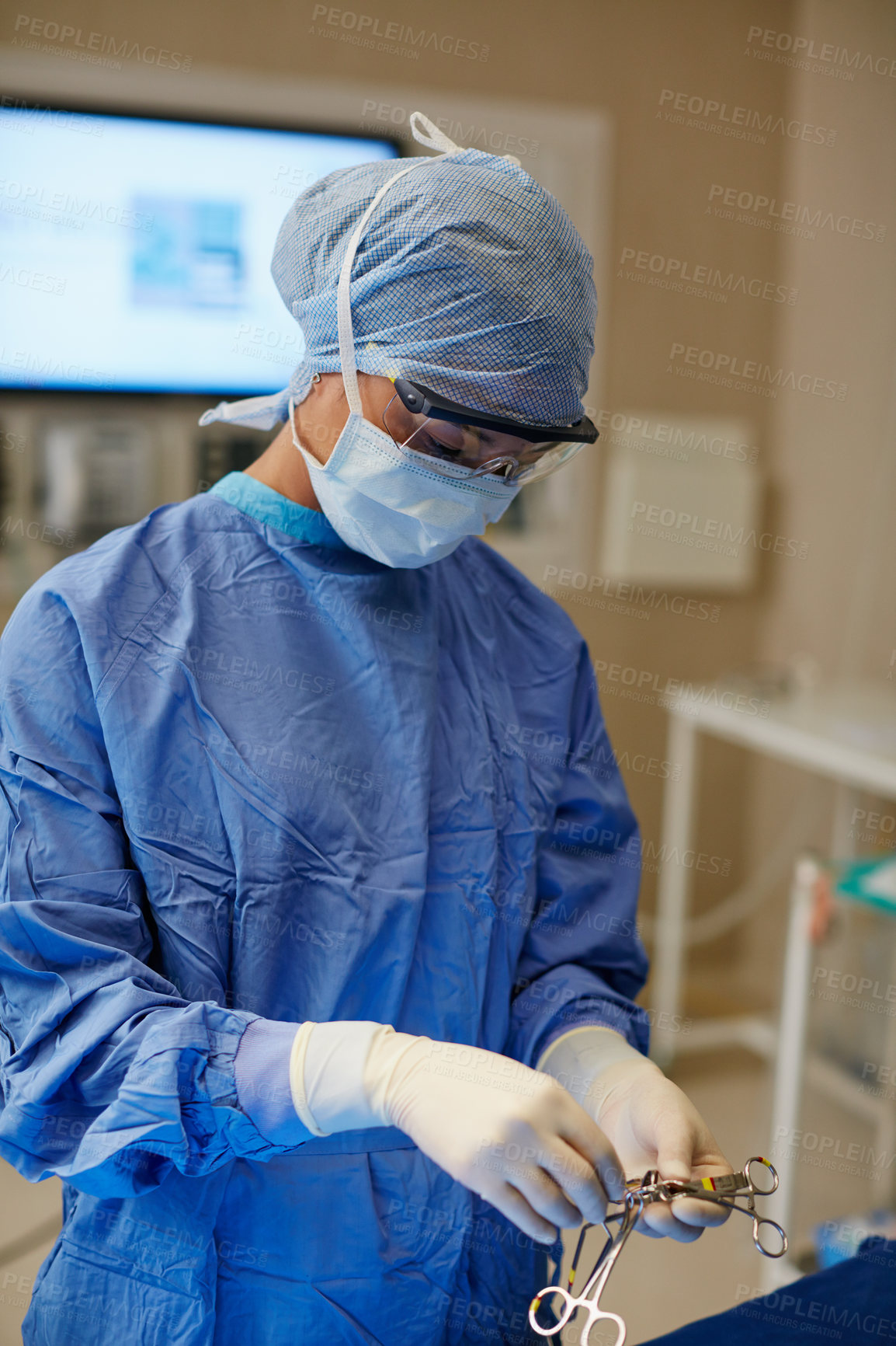 Buy stock photo Shot of a surgeon preparing her tools for a surgical operation